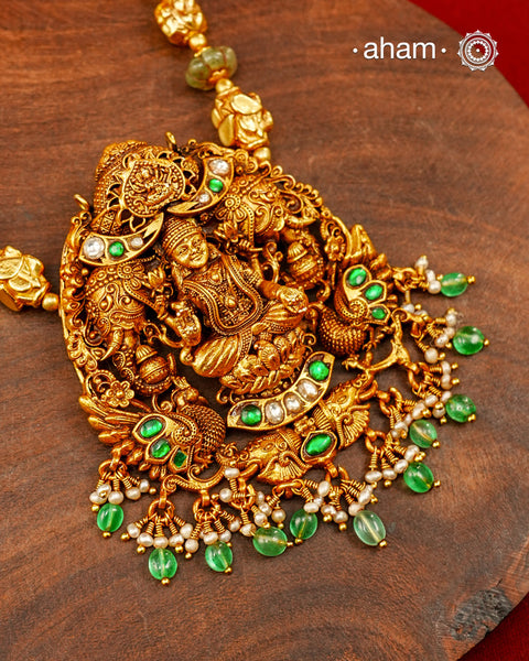 A magnificent celebration of prosperity, devotion, and Indian craftsmanship, this statement necklace is handcrafted in 92.5 sterling silver with a luxurious gold polish. At its heart sits Goddess Lakshmi, gracefully seated on a lotus, framed by intricately sculpted peacocks and elephants—symbols of beauty, wisdom, abundance, and royal grace in Indian iconography.
