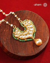 This stunning neckpiece features a delicate 92.5 silver chain with fresh water pearls and beautifully crafted fine kundan gold polished pendant. Add a touch of elegance to your look with this unique and timeless piece.