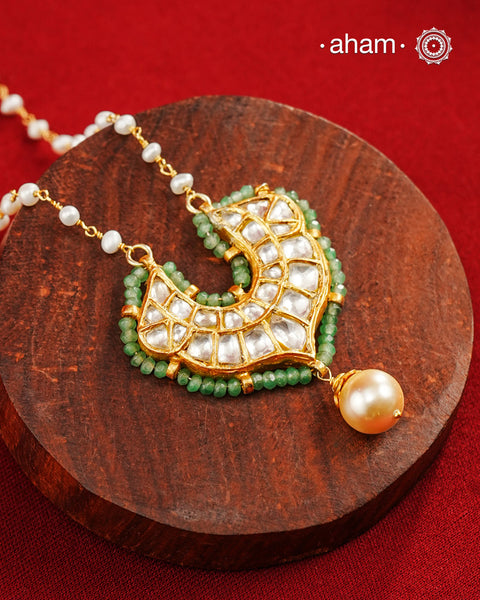 This stunning neckpiece features a delicate 92.5 silver chain with fresh water pearls and beautifully crafted fine kundan gold polished pendant. Add a touch of elegance to your look with this unique and timeless piece.
