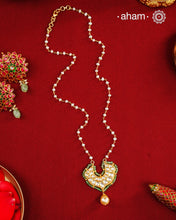 This stunning neckpiece features a delicate 92.5 silver chain with fresh water pearls and beautifully crafted fine kundan gold polished pendant. Add a touch of elegance to your look with this unique and timeless piece.