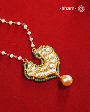 This stunning neckpiece features a delicate 92.5 silver chain with fresh water pearls and beautifully crafted fine kundan gold polished pendant. Add a touch of elegance to your look with this unique and timeless piece.