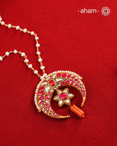 This stunning neckpiece features a delicate 92.5 silver chain with fresh water pearls and beautifully crafted fine kundan gold polished pendant. Add a touch of elegance to your look with this unique and timeless piece.