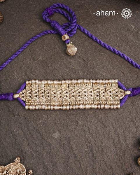 This Tribal Lotus Silver Choker exemplifies the refined craftsmanship of Orissa, skillfully handcrafted in pure silver. Featuring a stunning lotus motif, it embodies traditional artistry with a contemporary appeal. Perfect for those who value expert design and cultural heritage, this choker enhances any outfit with its elegant and distinctive presence.