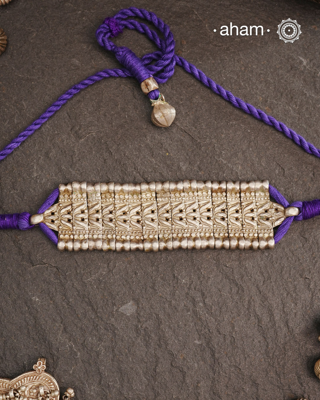 This Tribal Lotus Silver Choker exemplifies the refined craftsmanship of Orissa, skillfully handcrafted in pure silver. Featuring a stunning lotus motif, it embodies traditional artistry with a contemporary appeal. Perfect for those who value expert design and cultural heritage, this choker enhances any outfit with its elegant and distinctive presence.