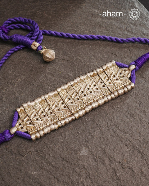 This Tribal Lotus Silver Choker exemplifies the refined craftsmanship of Orissa, skillfully handcrafted in pure silver. Featuring a stunning lotus motif, it embodies traditional artistry with a contemporary appeal. Perfect for those who value expert design and cultural heritage, this choker enhances any outfit with its elegant and distinctive presence.