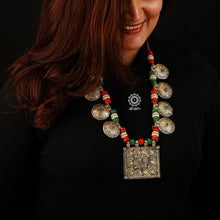 Handcrafted tribal silver neckpiece with floral and peacock motifs. Beautiful tribal silver pieces threaded together including red and green work. This necklace truly exemplifies the continuity of the traditional prototypes.