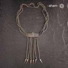 Transform your look with our Vintage Silver Belt Neckpiece. This unique accessory is crafted from a beautiful vintage belt sourced from the south of India and features fine rava work on the main buckle. Elevate any outfit with this versatile and stylish addition to your wardrobe.