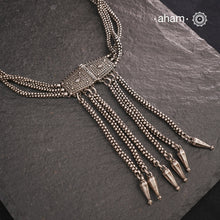 Transform your look with our Vintage Silver Belt Neckpiece. This unique accessory is crafted from a beautiful vintage belt sourced from the south of India and features fine rava work on the main buckle. Elevate any outfit with this versatile and stylish addition to your wardrobe.