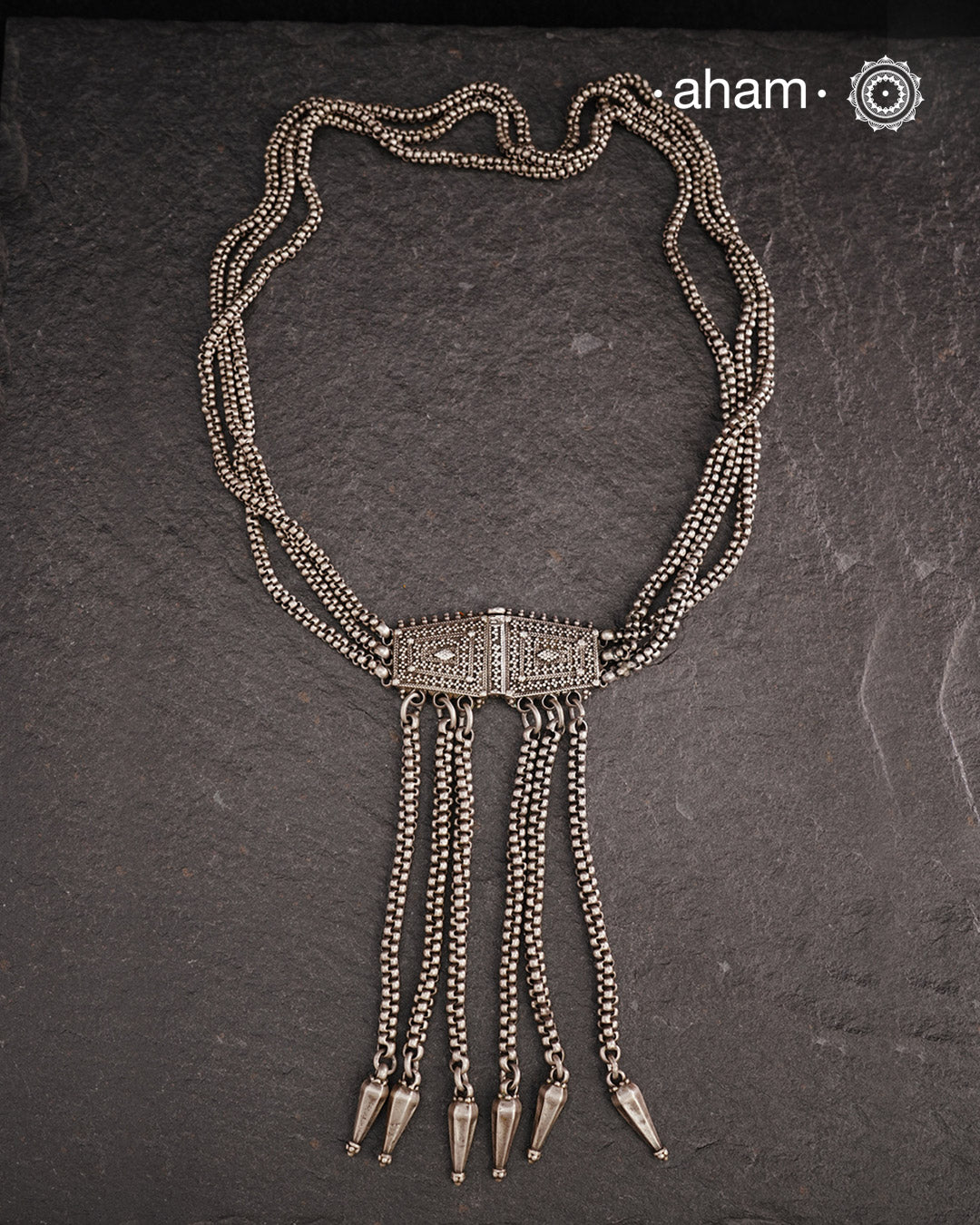Transform your look with our Vintage Silver Belt Neckpiece. This unique accessory is crafted from a beautiful vintage belt sourced from the south of India and features fine rava work on the main buckle. Elevate any outfit with this versatile and stylish addition to your wardrobe.
