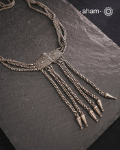 Transform your look with our Vintage Silver Belt Neckpiece. This unique accessory is crafted from a beautiful vintage belt sourced from the south of India and features fine rava work on the main buckle. Elevate any outfit with this versatile and stylish addition to your wardrobe.