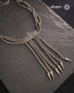 Transform your look with our Vintage Silver Belt Neckpiece. This unique accessory is crafted from a beautiful vintage belt sourced from the south of India and features fine rava work on the main buckle. Elevate any outfit with this versatile and stylish addition to your wardrobe.