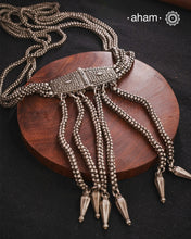 Transform your look with our Vintage Silver Belt Neckpiece. This unique accessory is crafted from a beautiful vintage belt sourced from the south of India and features fine rava work on the main buckle. Elevate any outfit with this versatile and stylish addition to your wardrobe.