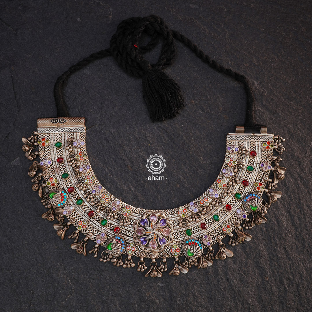 This Tribal Anklet has been transformed into a stunning Silver Neckpiece featuring vibrant glass stones. Handcrafted with care, this vintage piece adds a touch of color and heritage to any outfit. Perfect for those who appreciate unique and one-of-a-kind jewellery.