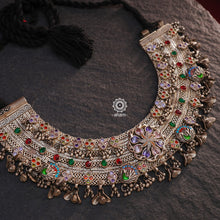 This Tribal Anklet has been transformed into a stunning Silver Neckpiece featuring vibrant glass stones. Handcrafted with care, this vintage piece adds a touch of color and heritage to any outfit. Perfect for those who appreciate unique and one-of-a-kind jewellery.