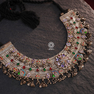 This Tribal Anklet has been transformed into a stunning Silver Neckpiece featuring vibrant glass stones. Handcrafted with care, this vintage piece adds a touch of color and heritage to any outfit. Perfect for those who appreciate unique and one-of-a-kind jewellery.