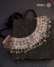 This Tribal Silver Anklet has been transformed into a stunning Neckpiece featuring vibrant glass stones. Handcrafted with care, this vintage piece adds a touch of color and heritage to any outfit. Perfect for those who appreciate unique and one-of-a-kind jewellery.