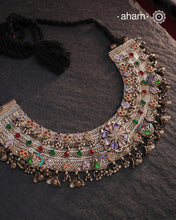 This Tribal Silver Anklet has been transformed into a stunning Neckpiece featuring vibrant glass stones. Handcrafted with care, this vintage piece adds a touch of color and heritage to any outfit. Perfect for those who appreciate unique and one-of-a-kind jewellery.