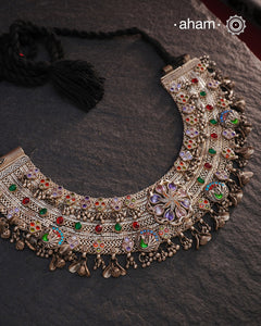 This Tribal Silver Anklet has been transformed into a stunning Neckpiece featuring vibrant glass stones. Handcrafted with care, this vintage piece adds a touch of color and heritage to any outfit. Perfect for those who appreciate unique and one-of-a-kind jewellery.