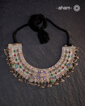 This Tribal Silver Anklet has been transformed into a stunning Neckpiece featuring vibrant glass stones. Handcrafted with care, this vintage piece adds a touch of color and heritage to any outfit. Perfect for those who appreciate unique and one-of-a-kind jewellery.