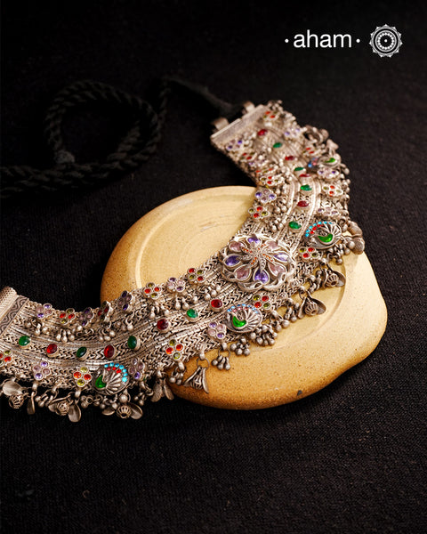 This Tribal Silver Anklet has been transformed into a stunning Neckpiece featuring vibrant glass stones. Handcrafted with care, this vintage piece adds a touch of color and heritage to any outfit. Perfect for those who appreciate unique and one-of-a-kind jewellery.