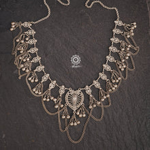 This Tribal Heart Silver Neckpiece is a stunning piece that is lightweight and expertly crafted in silver. With its intricate design and elegant shape, this piece is sure to catch eyes and add a touch of vintage vibes to any outfit. Perfect for any occasion.