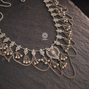 This Tribal Heart Silver Neckpiece is a stunning piece that is lightweight and expertly crafted in silver. With its intricate design and elegant shape, this piece is sure to catch eyes and add a touch of vintage vibes to any outfit. Perfect for any occasion.