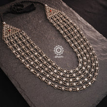 Crafted by skilled artisans, this Tribal Silver Neckpiece is a stunning addition to any jewelry collection. Its vintage design and 5 strands make it a beautiful statement piece. Made with high-quality silver, this rani haar is perfect for adding a touch of elegance to any outfit.