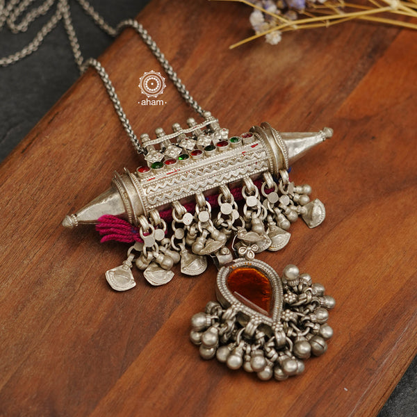 Long silver neckpiece made by putting together some unique vintage tribal silver pieces. Looks great when paired with workwear kurtas, saris or even a shirt.  Please note the glass drop is a deep yellow. 