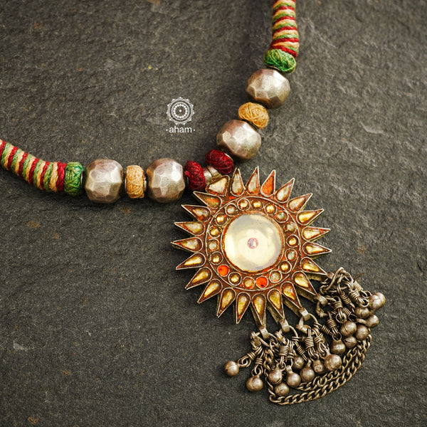 Experience true Indian craftsmanship with our Tribal Glass Silver Neckpiece. Handmade in Saranpur, UP, this beautiful vintage glass pendant is adorned with delicate silver beads and woven with soft cotton thread. Elevate any outfit with this unique and expertly crafted piece.