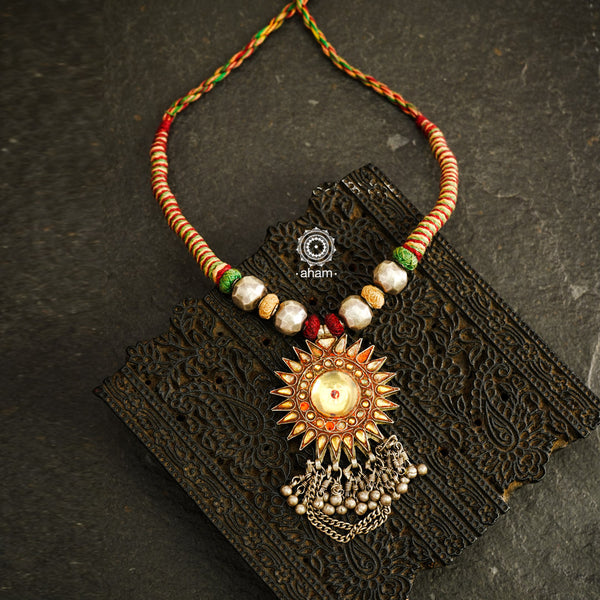 Experience true Indian craftsmanship with our Tribal Glass Silver Neckpiece. Handmade in Saranpur, UP, this beautiful vintage glass pendant is adorned with delicate silver beads and woven with soft cotton thread. Elevate any outfit with this unique and expertly crafted piece.