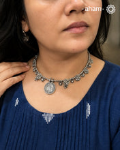 Wire Hasli with beautiful tribal silver pieces with a vintage coin as the center pendant.Pair it with your Indian wear. Simple yet striking design. The hasli is openable and you can pair the same with any other beads or change the sequence of the pendants as well to make your own unique design.