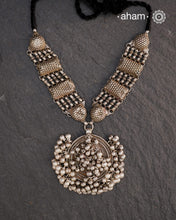 This Tribal Silver Neckpiece features a stunning vintage Ghungroo pendant and delicate silver bands. A perfect accessory for celebrating Navratri, this necklace adds a touch of traditional elegance to any outfit. Embrace cultural heritage with this unique piece.