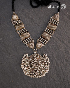 This Tribal Silver Neckpiece features a stunning vintage Ghungroo pendant and delicate silver bands. A perfect accessory for celebrating Navratri, this necklace adds a touch of traditional elegance to any outfit. Embrace cultural heritage with this unique piece.