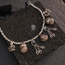 This tribal silver neckpiece is a stunning statement piece, handcrafted with a collection of unique vintage silver pieces. Our expertly designed composition features beautiful borlas and silver trinkets, making it truly one of a kind. The neckpiece comes with a soft cotton adjustable thread for ease of wearing and you can easily adjust length to your liking. Elevate your style with this striking and elegant accessory.