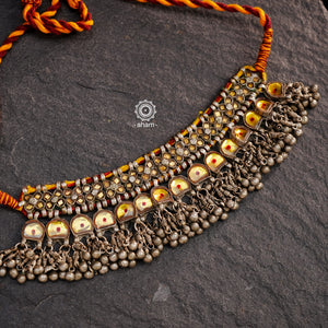 Handcrafted tribal Katesari silver choker with a beautiful sarafa from the state of Uttar Pradesh.
As it is a valuable ornament the Katesari choker was worn by the women mainly on festive occasions and marriage ceremonies. Each lower unit of the Katesari choker contain a yellow foil-backed clear-glass with an auspicious red dot (tikka) in the centre. The dot is meant to denote the centre point for one's spiritual destiny and serve as a medium for personal sanctification in the Hindu mythology.

