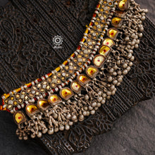 Handcrafted tribal Katesari silver choker with a beautiful sarafa from the state of Uttar Pradesh.
As it is a valuable ornament the Katesari choker was worn by the women mainly on festive occasions and marriage ceremonies. Each lower unit of the Katesari choker contain a yellow foil-backed clear-glass with an auspicious red dot (tikka) in the centre. The dot is meant to denote the centre point for one's spiritual destiny and serve as a medium for personal sanctification in the Hindu mythology.

