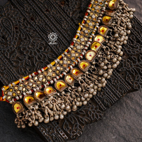 Handcrafted tribal Katesari silver choker with a beautiful sarafa from the state of Uttar Pradesh.
As it is a valuable ornament the Katesari choker was worn by the women mainly on festive occasions and marriage ceremonies. Each lower unit of the Katesari choker contain a yellow foil-backed clear-glass with an auspicious red dot (tikka) in the centre. The dot is meant to denote the centre point for one's spiritual destiny and serve as a medium for personal sanctification in the Hindu mythology.

