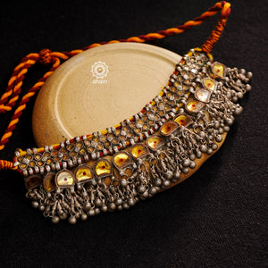 Handcrafted tribal Katesari silver choker with a beautiful sarafa from the state of Uttar Pradesh.
As it is a valuable ornament the Katesari choker was worn by the women mainly on festive occasions and marriage ceremonies. Each lower unit of the Katesari choker contain a yellow foil-backed clear-glass with an auspicious red dot (tikka) in the centre. The dot is meant to denote the centre point for one's spiritual destiny and serve as a medium for personal sanctification in the Hindu mythology.

