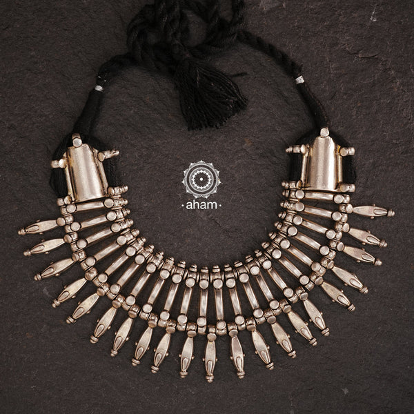 This tribal silver neckpiece is a re-creation of a popular design from the Himalayan foothills. Crafted in silver, it offers a unique and striking accessory that showcases traditional craftsmanship. Elevate your style with this beautiful piece.