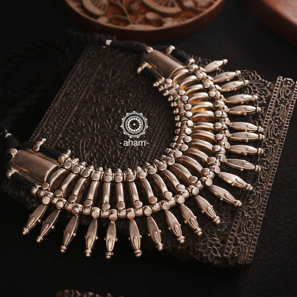 This tribal silver neckpiece is a re-creation of a popular design from the Himalayan foothills. Crafted in silver, it offers a unique and striking accessory that showcases traditional craftsmanship. Elevate your style with this beautiful piece.