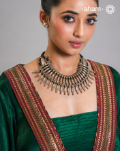 This tribal silver neckpiece is a re-creation of a popular design from the Himalayan foothills. Crafted in silver, it offers a unique and striking accessory that showcases traditional craftsmanship. Elevate your style with this beautiful piece.