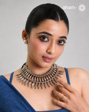 This tribal silver neckpiece is a re-creation of a popular design from the Himalayan foothills. Crafted in silver, it offers a unique and striking accessory that showcases traditional craftsmanship. Elevate your style with this beautiful piece.