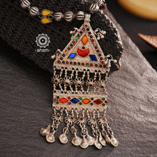 Experience the elegance and timelessness of our Tribal Silver Neckpiece. Handcrafted with a vintage silver piece, highlighted with vibrant coloured glass, and adorned with  silver beads, this necklace is a true statement of style. Complement any outfit with its unique and intricate design.