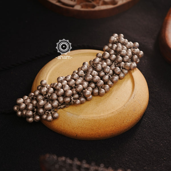 Experience the versatility and cultural charm with our Tribal Ghungroo Silver Choker. Adorned with multiple ghungroos, it can be styled as a choker, arm band, as gajra in your hair or as a bracelet, allowing you to get creative with your look this Navratri. Made of silver, this piece will add an elegant touch to any outfit.