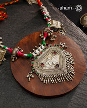 Crafted in stunning silver, this Tribal Silver Neckpiece is a one of a kind accessory that showcases a beautiful combination of vintage pieces threaded together. Its unique design is perfect for Navratri celebrations, making it a must-have addition to your jewellery collection. Elevate any outfit with its elegant, statement-making style.