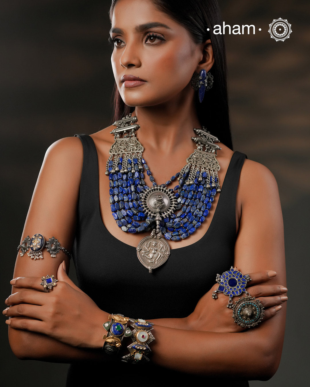 This Tribal Silver Neckpiece is a unique masterpiece designed to make a bold statement. Crafted from vintage silver pieces, it features lapiz stones. Its versatile design complements both traditional and western outfits, offering a distinctive touch to your style. Perfect for those who appreciate unique statement pieces. 