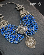 This Tribal Silver Neckpiece is a unique masterpiece designed to make a bold statement. Crafted from vintage silver pieces, it features lapiz stones. Its versatile design complements both traditional and western outfits, offering a distinctive touch to your style. Perfect for those who appreciate unique statement pieces.