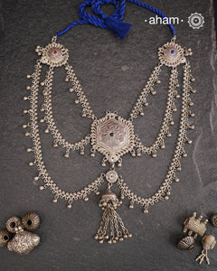 This Tribal Silver Neckpiece reimagines a classic waist belt into a stunning neckpiece, meticulously crafted from silver. Its lightweight design offers full torso coverage, creating a commanding and elegant presence. Ideal for those who appreciate traditional artistry.