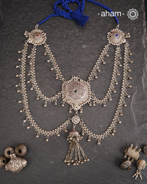 This Tribal Silver Neckpiece reimagines a classic waist belt into a stunning neckpiece, meticulously crafted from silver. Its lightweight design offers full torso coverage, creating a commanding and elegant presence. Ideal for those who appreciate traditional artistry.