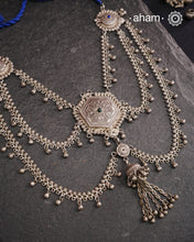 This Tribal Silver Neckpiece reimagines a classic waist belt into a stunning neckpiece, meticulously crafted from silver. Its lightweight design offers full torso coverage, creating a commanding and elegant presence. Ideal for those who appreciate traditional artistry.
